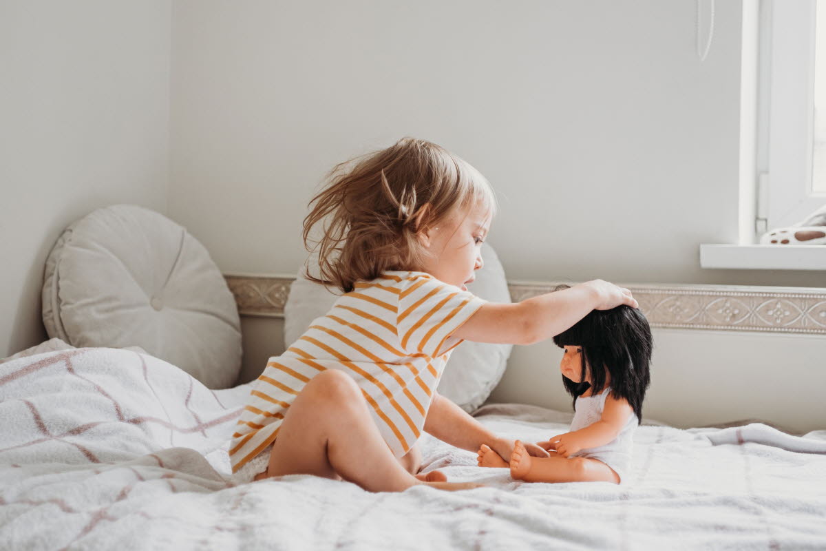 toddler-girl-playing-with-doll-2022-11-17-14-24-54-utc